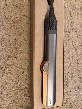 Dyson hair straightener in gray with copper accents